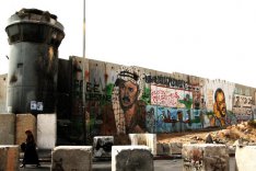 A woman passes the Qalandiya Checkpoint in Ramallah.