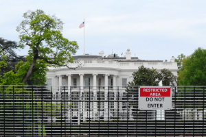 Auf einem Schild am Zaun vor dem Weißen Haus steht "Do not enter".