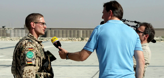 Soldat in einem Feldlager bei einem Fernsehinterview