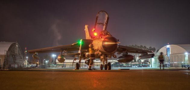 Maintenance crews investigate the fighter jet \"Tornado\" on the airfield between two hangars at the air base Incirlik on February 24, 2016.